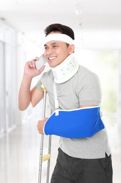 Injured young man talking on the phone