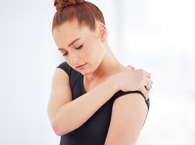 Injury can occur in any sport and ballet is no exception Shot of a young ballerina suffering from shoulder pain