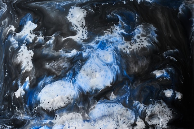 Ink abstract background black white blue pattern of paint under water acrylic pigment stains splashes and streaks