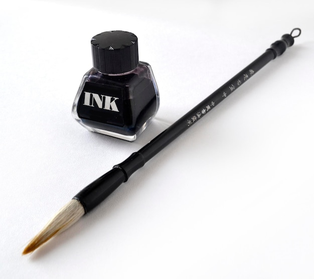 Ink bottle with brush for painting chinese painting on white