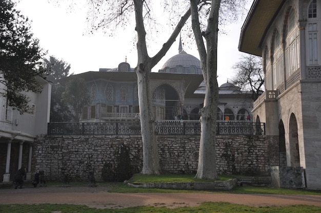 The inner courtyard of the Topkapi Palace. Old buildings and a stone wall.