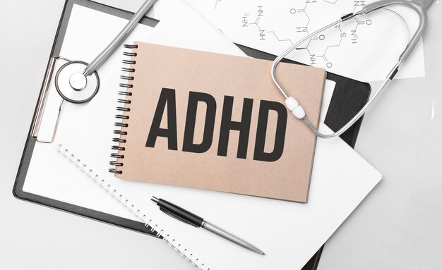 Foto inschrijving adhd. bovenaanzicht van de tafel met stethoscoop, pen en medische documenten.