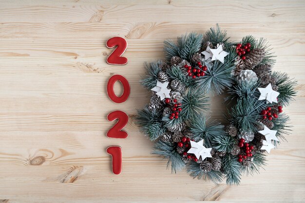 Inscription 2021 on wooden background. Christmas background. Christmas decor.