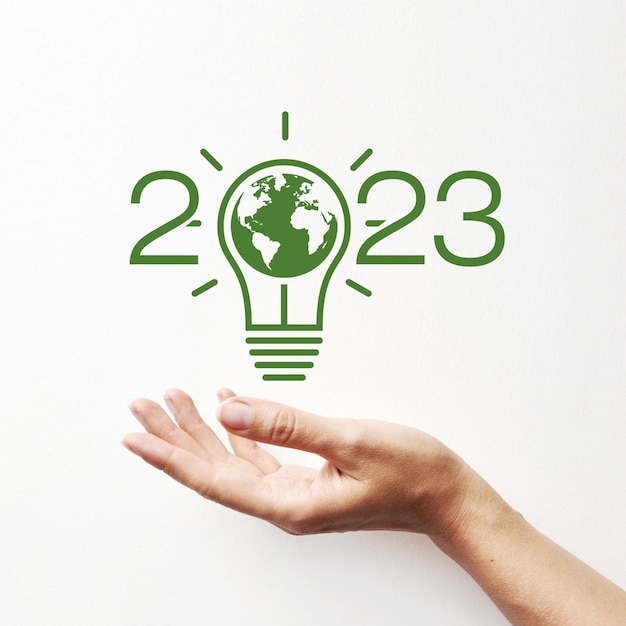 Inscription 2023 with an image of a light bulb and a planet in it A symbol of environmental protection in the new year