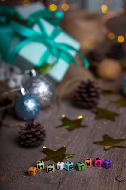 Inscription Christmas and group of gifts on the background of garlands