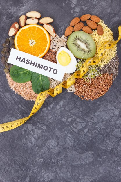 Inscription hashimoto with nutritious ingredients fruits and vegetables in shape of thyroid Healthy lifestyles and food containing vitamins