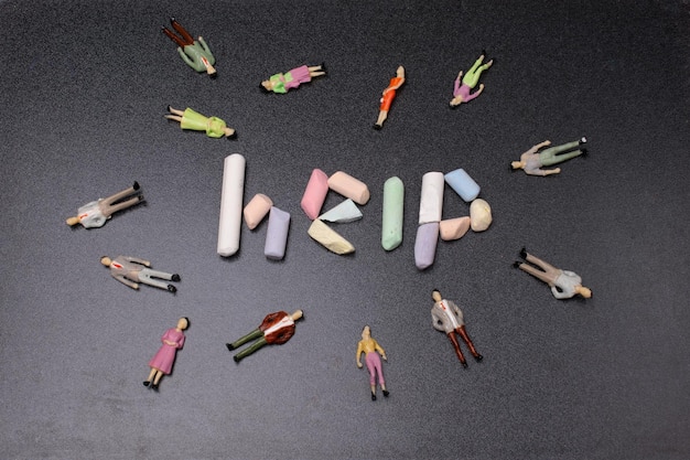 The inscription on the help of colored chalk beside people figurines