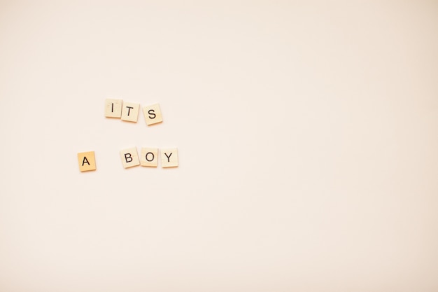 The inscription "It's a boy" from wooden blocks