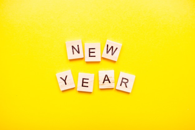 The inscription new year made of wooden blocks