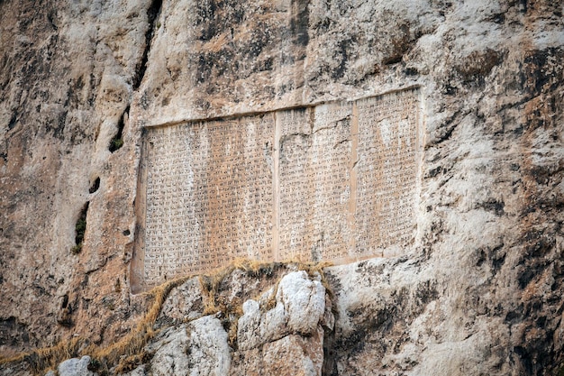 Inscription of Persian King Xerxes the Great on Van Rock, near Van Fortress, Turkey. It's written by cuneiform: 'I'm Xerxes, king of kings, by Ahuramazda favor, I ordered inscription be written, etc'