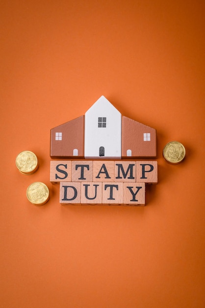 The inscription Stamp Duty made of wooden cubes on a plain background