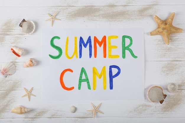 The inscription summer camp on a colored background top view