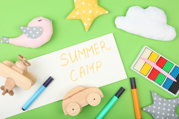 The inscription summer camp on a colored background top view