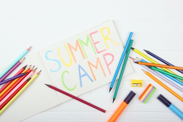 The inscription summer camp on a colored background top view