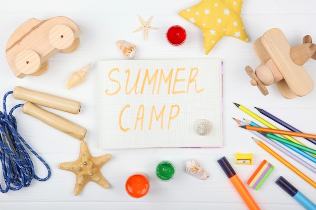 The inscription summer camp on a colored background top view