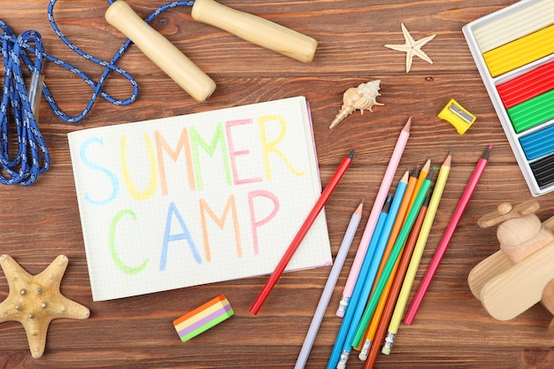 The inscription summer camp on a colored background top view