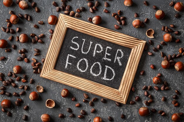 Надпись Super Food, различные орехи на каменном столе