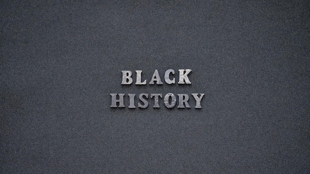 Inscription text black history month on dark isolated background close up celebrating the african