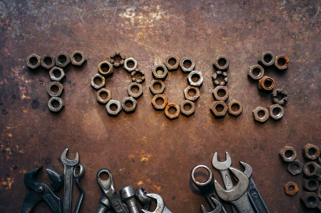 Inscription tools from nuts wrenches on rusty desk