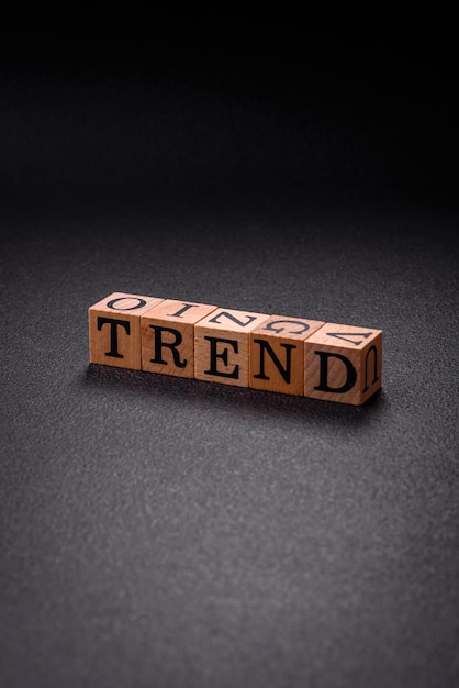 Photo the inscription trend made of wooden cubes on a plain background