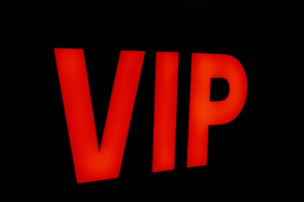 Inscription vip red letters on dark background