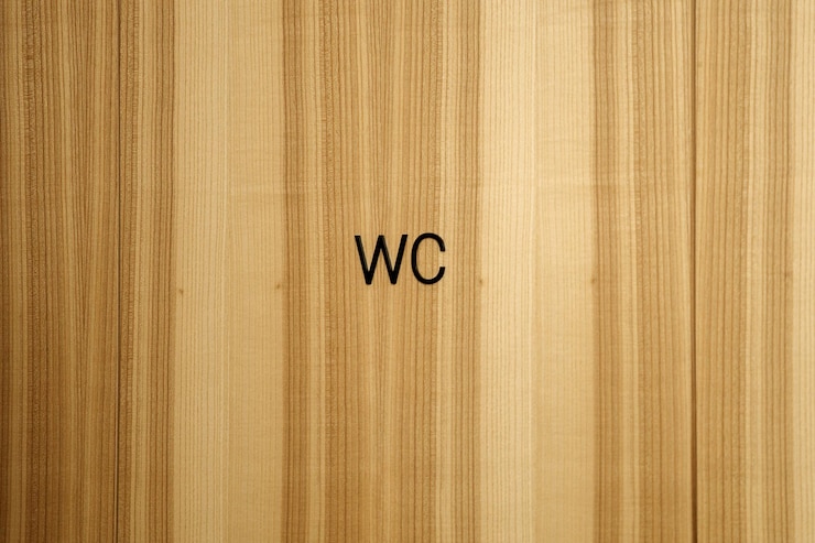 Photo 木製の壁のトイレの道標の碑文wc黒い文字からのテキスト茶色の木のテクスチャwcの碑文