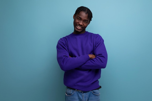 Insecure black american young guy with dreadlocks in casual clothes