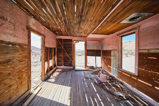 Inside abandoned and decaying wood room in desert