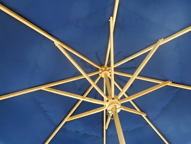 The inside of an open blue umbrella