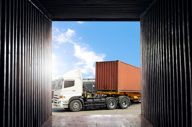 Inside view of shipping cargo container semi trailer trucks\
loading goods for transportation