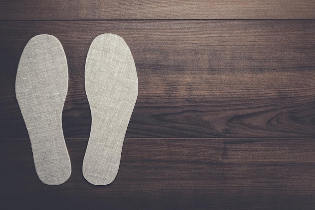 Insoles for shoes on wooden background