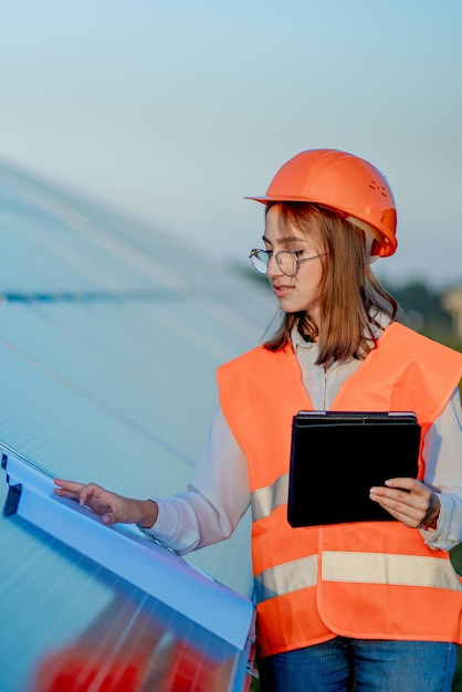 Inspector Engineer Woman Holding Digital Tablet Working in Solar Panels Power Farm Photovoltaic Cell Park Green Energy Concept