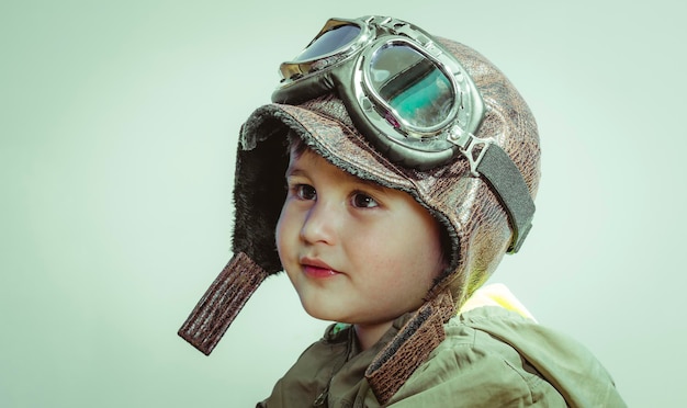 Inspiration, Cute little toddler boy, playing at home with playing wars and peace,funny child dressed in militar hat and goggles