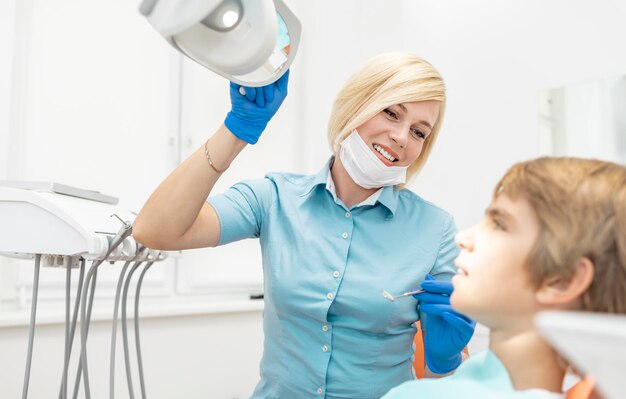Photo inspired blonde female dentist fitting dental