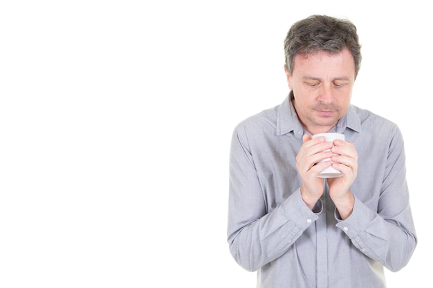 Inspired man with cup of fresh coffee tea with copy space side