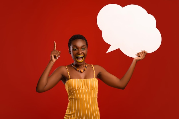 Inspired stylish black lady holding communication bubble and gesturing