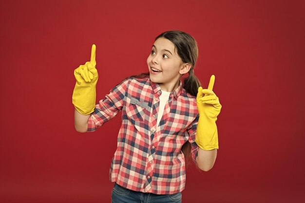 Inspiring changes Spring cleaning House cleaning service Cleaning supplies Small girl rubber gloves for cleaning red background Appreciate cleanliness Clean house Housekeeping duties