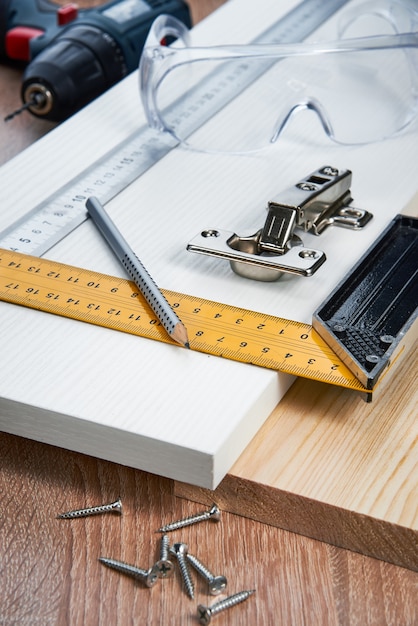 Photo installation of furniture hinges in the chipboard tools and accessories