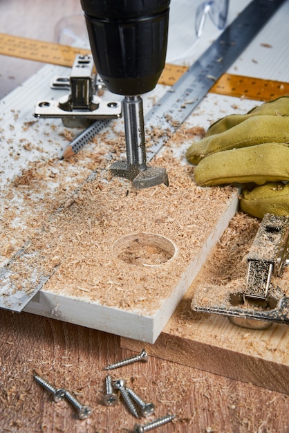 Installation of furniture hinges in the chipboard tools and accessories