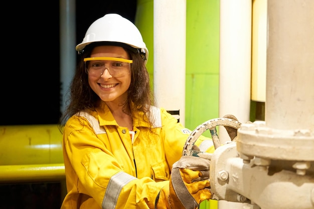 Installation showing the process of drilling an oil well Woman in worker suit on site