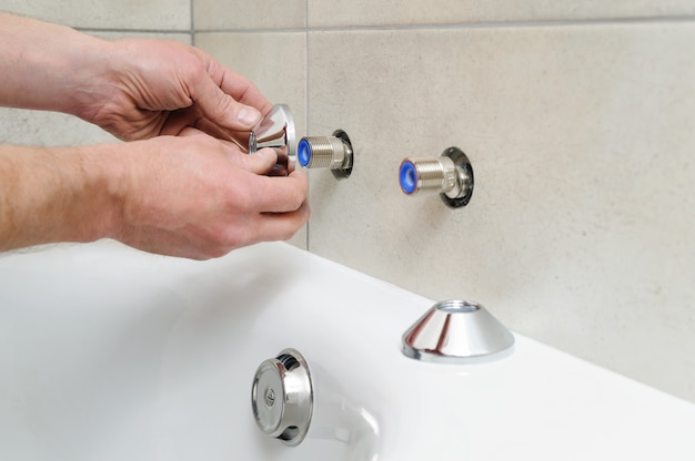 Installing bath faucet.