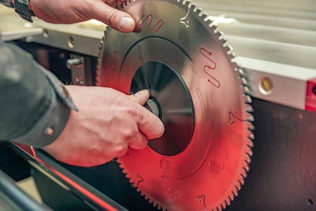 installing the circular saw blade on the woodworking machine close up