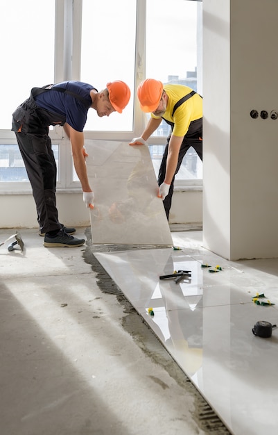 Installing a large ceramic tile.