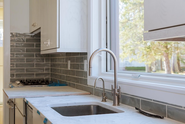 Photo installing new induction hob in modern kitchen cabinets installation