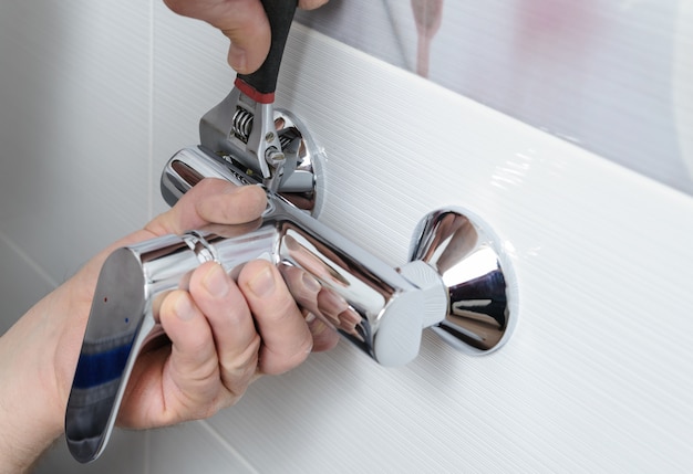 Installing a shower faucet.