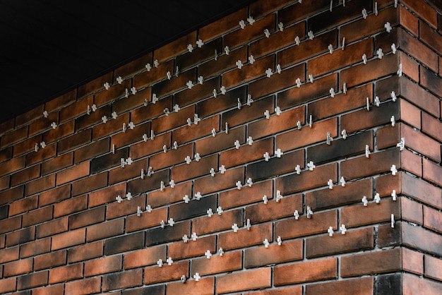 Installing the tiles in the form of brick on the wall using plastic crosses between the tiles.