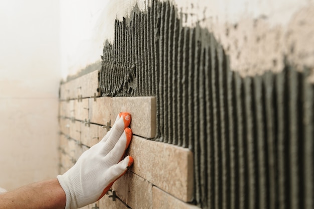 Installing the tiles on the wall.