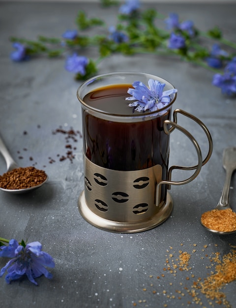 Instant chicory root drink in glass on gray