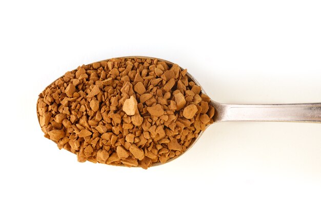 Instant coffee granules in a spoon isolate.