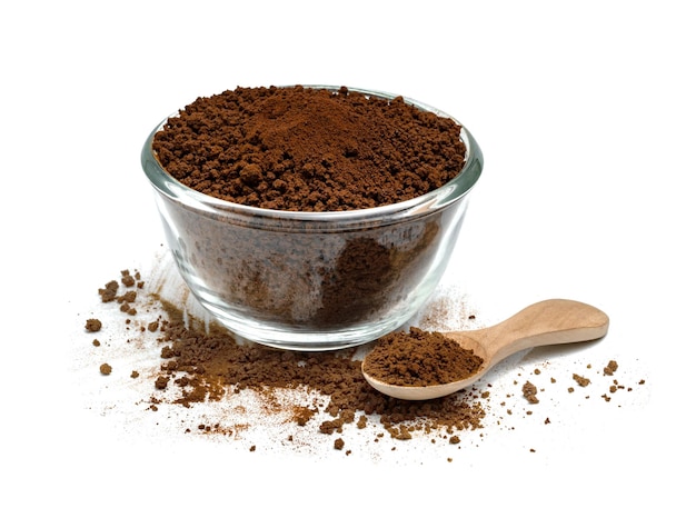 Instant coffee powder with glass bowl and wooden spoon isolated on white background